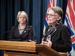 Provincial health officer Dr. Bonnie Henry (left) watches as Dr. Penny Ballem, head of coastal health and B.C. immunization efforts, speaks during a briefing on the next phase of B.C.'s COVID-19 immunization plan.