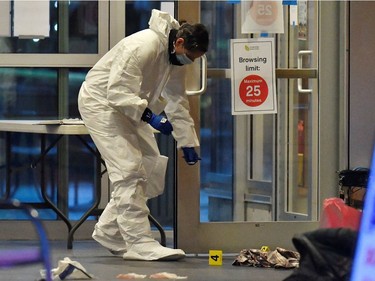 A first responder works at a crime scene where police said multiple people were stabbed by a suspect who was later taken into custody at a public library in the Lynn Valley neighbourhood of North Vancouver, March 27, 2021.