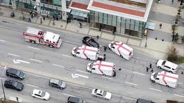 Ambulances and emergency personnel are seen on a road outside Lynn Valley Main Library, where police said multiple people were stabbed by a suspect who was later taken into custody, in North Vancouver, March 27, 2021, in this still image from video obtained via social media.