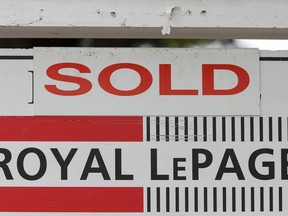 A Royal LePage real estate sign is marked "Sold" in front of a house in Ottawa.