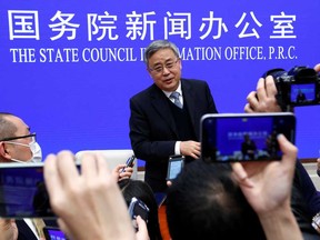 Guo Shuqing, chairman of the China Banking and Insurance Regulatory Commission, answers questions at a news conference in Beijing on Tuesday. The nation's top banking regulator jolted markets on Tuesday with a warning about the need to reduce leverage amid the rising risk of bubbles globally and in the local property sector.