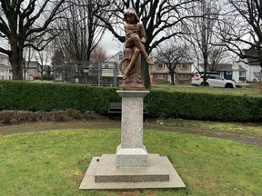 A statue of young Christopher Columbus when it was at the Italian Gardens at Hastings Park in Vancouver. Note the tinges of red, remnants of being doused in red paint by protesters.