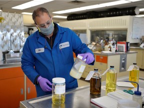 Bill Sihota, refinery lab supervisor, handles a jar of tallow at Parkland Fuel's refinery in Burnaby.