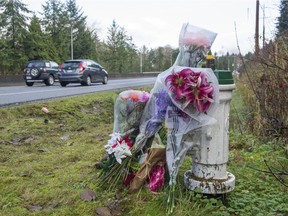 Memorial flowers Saturday, December 1, 2018 along the Barnett Highway in Burnaby near the spot where Nicole Hasselmann was killed.