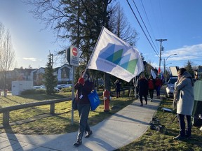 Some teachers and staff at École Woodward Hill Elementary School in Surrey on Feb. 23, 2021, after seven schools in the Fraser Health region reported exposures to a COVID-19 variant.