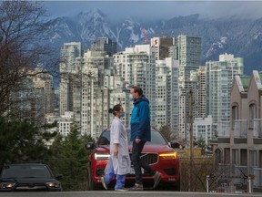VANCOUVER, BC - February 25, 2021  - People walk along West Broadway in Vancouver, BC, February 25, 2021. 

Photo by Arlen Redekop / Vancouver Sun / The Province News (PNG) (story by  reporter) [PNG Merlin Archive]