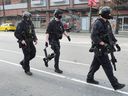 A Vancouver Police Department tactical officer responds to the shooting at the Arco Hotel Wednesday morning.