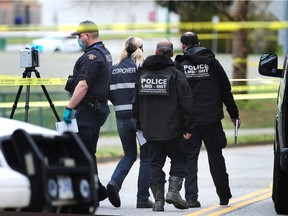 Integrated Homicide Investigation Team (IHIT) and the coroner on the scene of a suspected homicide at Greentree Village Park in Burnaby, BC., on March 18, 2021.