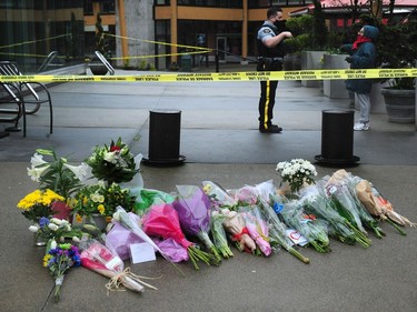 Local residents lay flowers at the scene the day after a mass stabbing that left one person dead at the Lynn Valley Library in North Vancouver.
