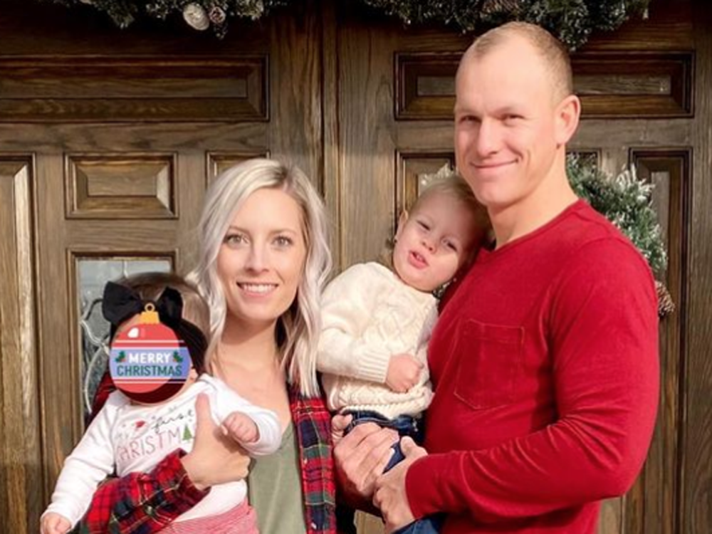 Emily and Brandon Chrislip with their son, Camden, and the 10-month-old surrogate baby they have been caring for.