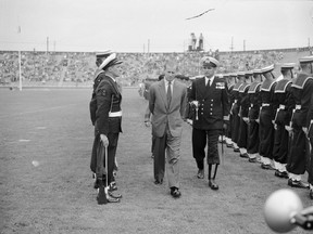 August 1954: Prince Philip, the Duke of Edinburgh, reviews cadets with Cmdr. Pickles at Empire Stadium.