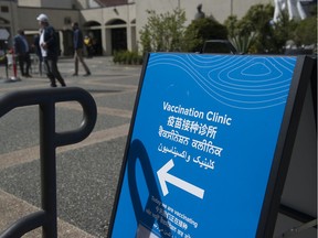 Signs point toward a COVID-19 vaccination clinic at the Italian Cultural Centre at 3075 Slocan Street in Vancouver on April 8, 2021. This clinic will be open to walk-ins on Aug. 4.