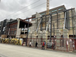 Steel beams support the facade of the historic Paradise Theatre at 845 Granville in Vancouver on April 7, 2021. The Paradise was built as the Globe Theatre in 1913 and was given an art deco look in 1938. The brick building down the street is the 1893 Palms Hotel, which has also been facaded as part of a new entertainment complex.