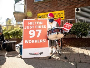 FILE PHOTO: Workers and supporters hold placards in front of the Hilton Vancouver Metrotown hotel on April 27.