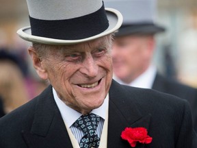 In this file photo taken on May 16, 2017 Britain's Prince Philip, Duke of Edinburgh greets guests at a garden party at Buckingham Palace in London on May 16, 2017.
