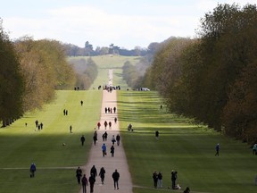 People stroll on the Long Walk outside Windsor Castle after Britain's Prince Philip, husband of Queen Elizabeth, died at the age of 99, in Windsor, near London, Britain, April 11, 2021.