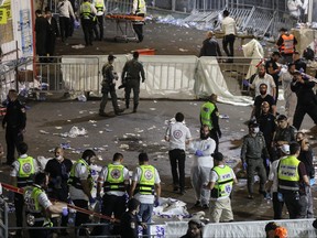 Medics and rescue workers attend to the Lag B'Omer event in Mount Meron, northern Israel, where fatalities were reported among the thousands of ultra-Orthodox Jews gathered at the tomb of a 2nd-century sage for annual commemorations that include all-night prayer and dance, at Mount Meron, Israel April 30, 2021.