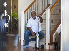 Atish Ram with an oxygen machine inside his Surrey home.