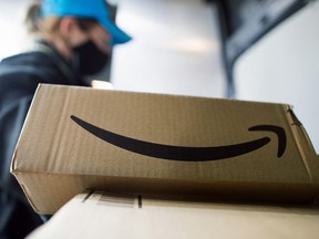 An Amazon delivery driver sorts through customer orders inside a delivery van in Leigh-on-Sea, U.K., on Thursday, Nov. 26, 2020.