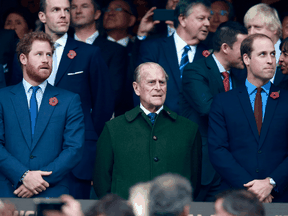 Prince Harry, Prince Philip and Prince William stand for the national anthems at to the 2015 Rugby World Cup Final match between New Zealand and Australia at Twickenham Stadium on Oct. 31, 2015 in London.