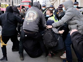 Police officers scuffle with demonstrators taking part in a ‘Kill The Bill’ protest against the British government’s police, crime, sentencing and courts bill in central London on April 3, 2021.