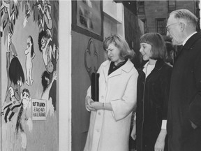 B.C.'s minister of works, William Neelands Chant, looks over a "primitive" painting at the "paint-in" on the construction hoarding outside the Vancouver courthouse on April 7, 1966. With Chant are his granddaughters Judy and Diana. Bill Cunningham/Province