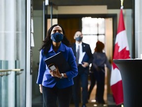 Chief Public Health Officer Dr. Theresa Tam and Dr. Howard Njoo, Deputy Chief Public Health Officer, make their way to hold a press conference during the COVID-19 pandemic in Ottawa on Friday, Dec. 18, 2020.