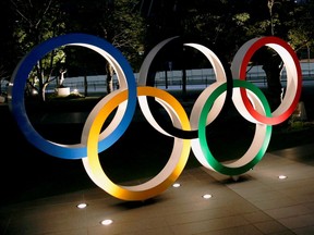 The Olympic rings are illuminated in front of the National Stadium in Tokyo on Jan. 22.