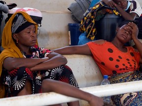 Women sit inside a displacement centre after fleeing an attack claimed by Islamic State-linked insurgents on the town of Palma, in Pemba, Mozambique, on April 2, 2021.