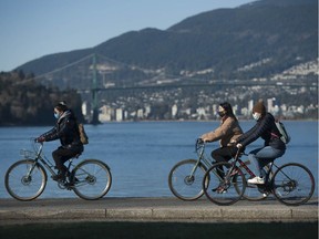 Cyclists take advantage of the sunny weather in Vancouver.