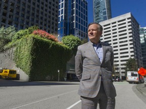 Jon Stovell of Reliance Properties stands near a parking garage at the corner of Melville and Thurlow Streets that he wants rezoned to permit a residential tower.