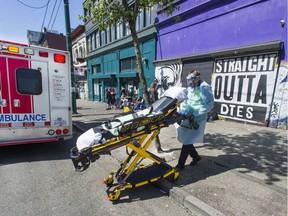 Paramedics respond to an emergency medical call in the 100-block E. Hastings Street in Vancouver, BC Thursday, April 22, 2021. Paramedics responded Wednesday to the highest number of drug overdose calls since the opioid crisis began.