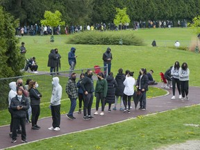 Hundreds of people wait in line for COVID-19 vaccines at a Fraser Health pop-up clinic at the Newton Athletic Park in Surrey on Wednesday, April 28, 2021.
