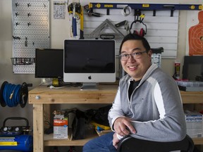 Jackie Chow dismantles a computer in his garage that he will refurbish as part of Buy Nothing Project, a community where goods and services are swapped or gifted to others for free.