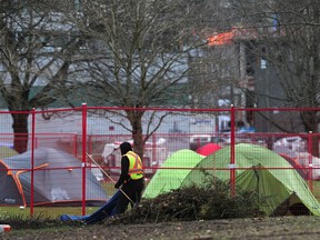 City of Vancouver crews clean the west side of Strathcona park after the east side was fenced off to accommodate the tent encampment in March.