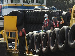 A file photo of tugboat workers in the Vancouver harbour. Many in the B.C. tugboat industry are calling for safety improvements after a series of sinkings and close calls.