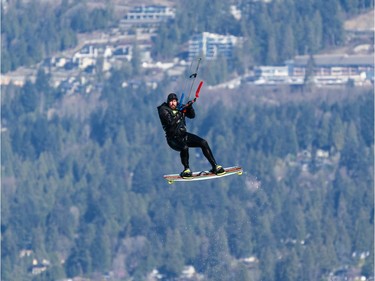 VANCOUVER,BC:APRIL 4, 2021 -- A kitesurfer flies through the air while kitesurfing at Kits Beach in Vancouver, BC, April, 4, 2021. (Richard Lam/PNG) (For ) 00064274A [PNG Merlin Archive]