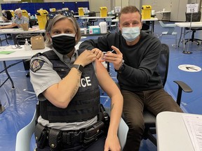 A handout photo of Surrey RCMP Sgt. Elenore Sturko getting her first COVID-19 vaccine April 12 at the South Surrey Recreation and Arts Centre.