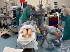 Handout photo of the Surrey Memorial Hospital simulation lab, and health-care workers. The lab has been instrumental in training workers to handle COVID-19.