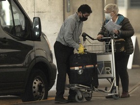 International air passengers at Vancouver International Airport board a shuttle for three days of quarantine.