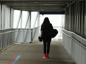 A passenger boards a ferry at the Horseshoe Bay ferry terminal as travel restrictions have gone into effect across B.C.