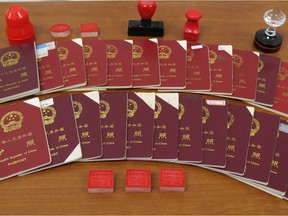 Some of the 172 mostly Chinese passports and fake border-crossing stamps found in the possession of Richmond's Sunny Wang.