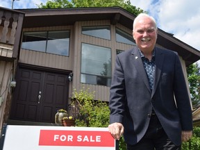 Realtor John Corrie stands in front of an Abbotsford house on May 4 at 35369 Rockwell Dr. that he is selling.