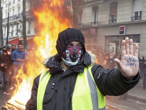 A protester at a burning barricade during May Day protests in Paris, France, on May 1, 2021.