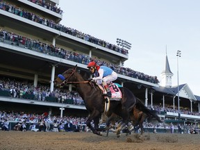 Medina Spirit, ridden by jockey John Velazquez, crosses the finish line to win the Kentucky Derby at Churchill Downs in Louisville, Ky., last weekend, before 52,000 fans in the stands.