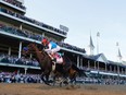 Medina Spirit #8, ridden by jockey John Velazquez, crosses the finish line to win the 147th running of the Kentucky Derby at Churchill Downs on May 1, 2021 in Louisville, Kentucky.