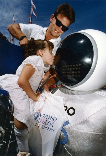 Expo Ernie. Special Kiss for Expo Ernie draws a shy giggle from six-year-old Kimberly Materi of New Westminster. Ran on known date on  pg. A1 Vancouvrer Sun. Peter Battistoni Vancouver Sun. TC # 86-4211 [PNG Merlin Archive] Sunday feature Expo 86 30th anniversary