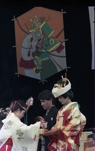 Happy Bride and Groom wed at Expo 86 during Shinto Japanese wedding at Xerox Theatre. Wesley Grant and Charleen Charles were married in ceremony that featured some 50 priests, musicians and dancers. Taken June 3, 1986. Bill Keay Vancouver Sun TC # 86-2710 [PNG Merlin Archive]