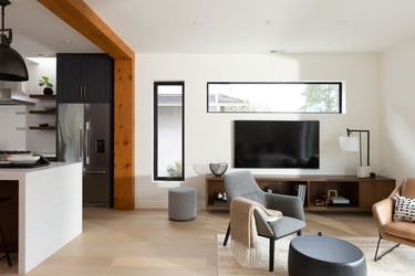 A century-old fir post and beam, sourced from Western Reclaimed Timber in Maple Ridge, divide the kitchen and living room.