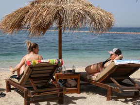 People enjoy the sun during the official reopening of beaches to the public, following the easing of measures against the spread of the coronavirus disease in Athens, Greece, May 8, 2021.